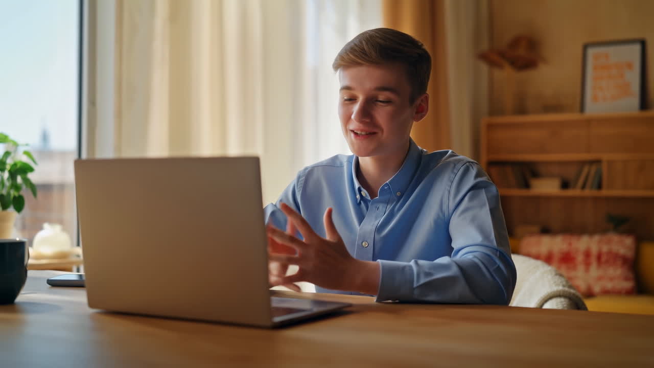 Teen Smiling During Video Call On Laptop, Cozy Home Study Setup, Warm Sunlight Through Curtains, Bookshelf