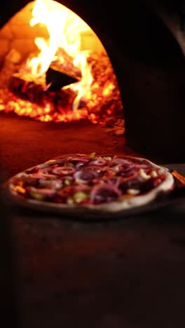 pizza baking in a wood-fired oven