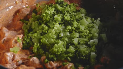 Adding-Chopped-Broccoli-Into-Cooked-Chicken-Breast-With-Low-Fat-Cheese-Mixture