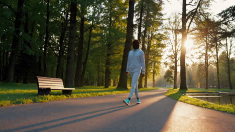 woman exercising in a park at sunrise/sunset