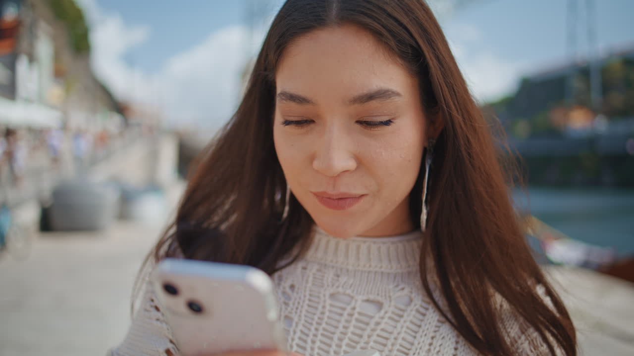 Inspired tourist taking photo on phone at summer city closeup. Woman vacation