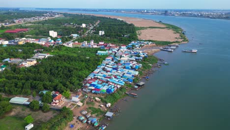 fishing village with colorful shacks along the mekong river in cambodia, a developing country in southeast asia. magic aerial view flight speed ramp hyper motion time lapse