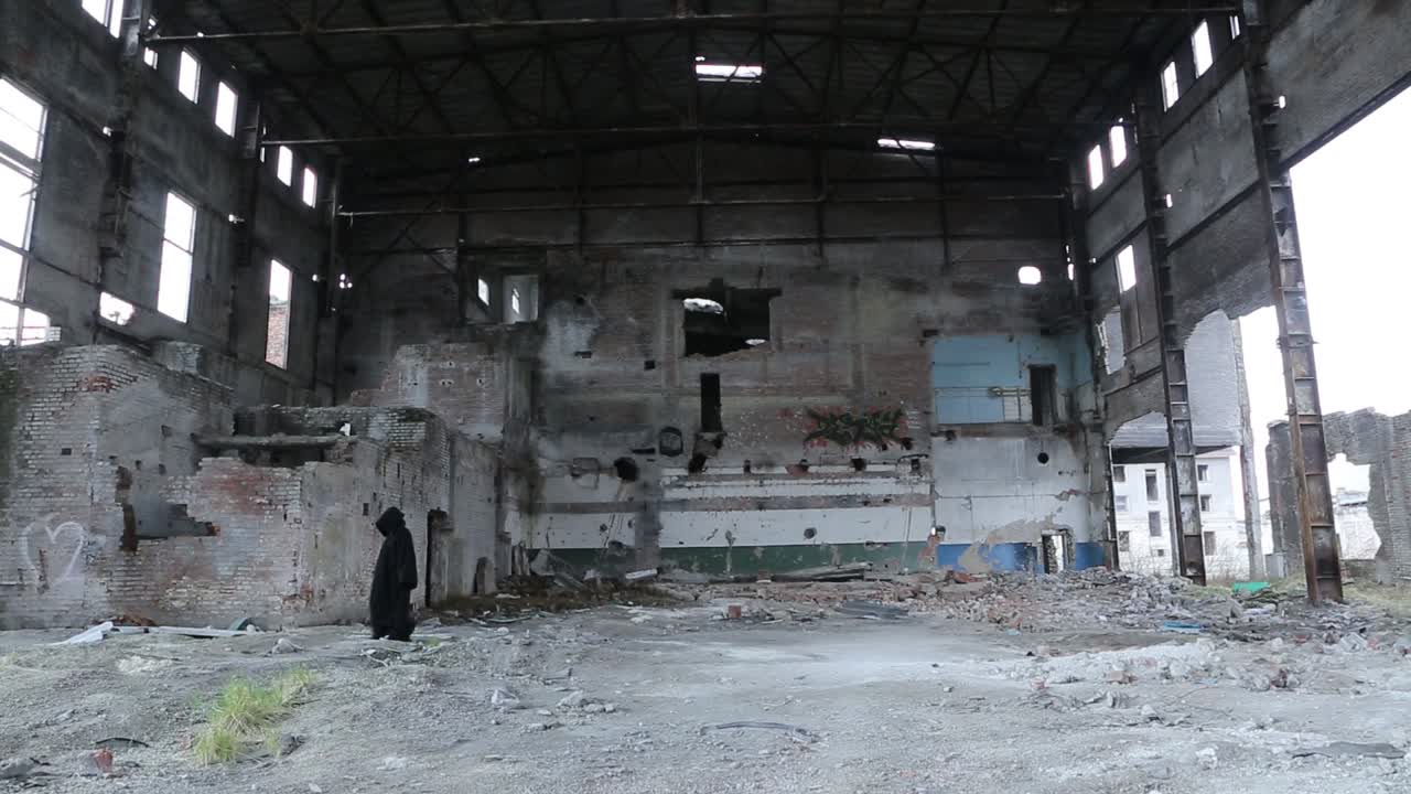 Ghost In Destroyed Building. Ghost in black cloak walking throug destroyed building