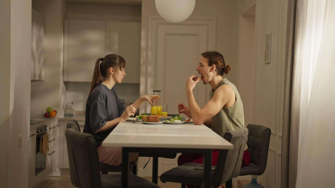 Couple having breakfast at the dining table in the kitchen