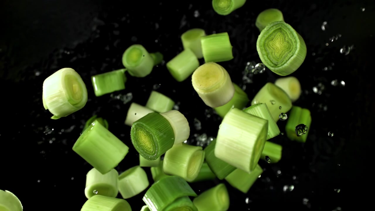 Slow Motion of Fresh Chopped Leeks Flying with Water Droplets