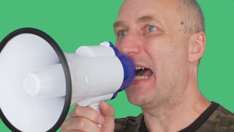 angry protester shouting in megaphone during political demonstration on green screen background