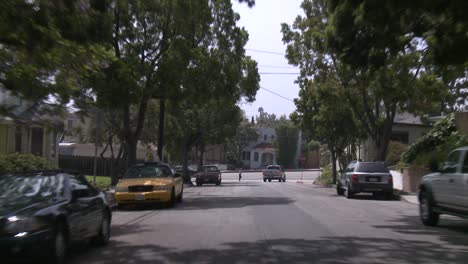 a car travels along a street in santa monica california as seen through the rear window 4