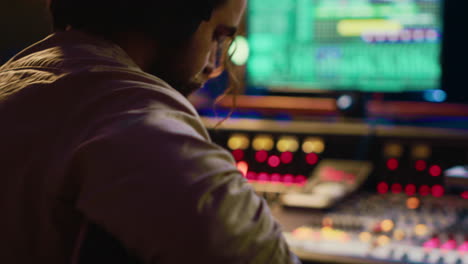 young composer songwriter recording his guitar tunes in professional studio