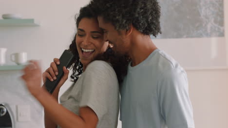 happy-young-couple-dancing-at-home-enjoying-funny-dance-having-fun-singing-together-celebrating