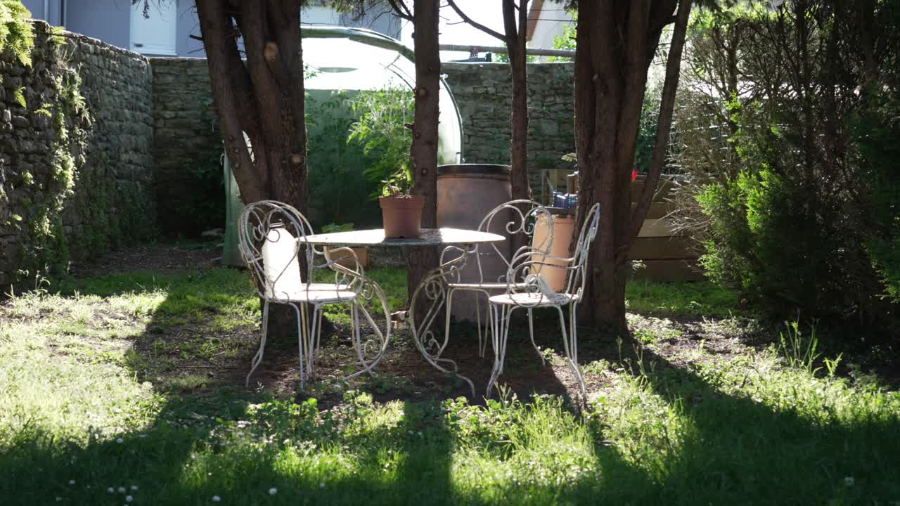 Peaceful Garden Scene with Vintage Metal Chairs and Table
