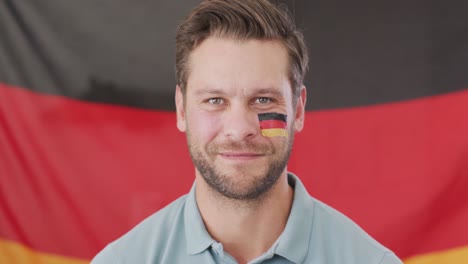 video of excited caucasian man with flag of germany watching match in tv