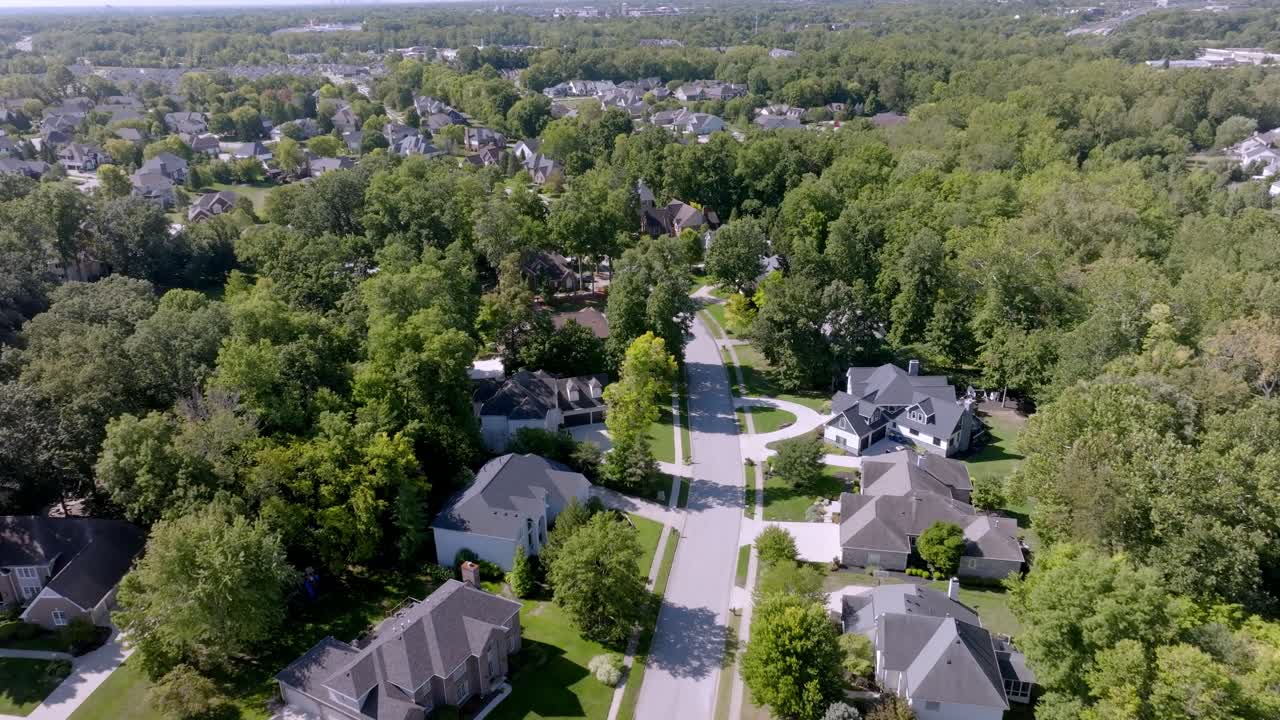 Neighborhood homes in Carmel, Indiana with drone video moving forward
