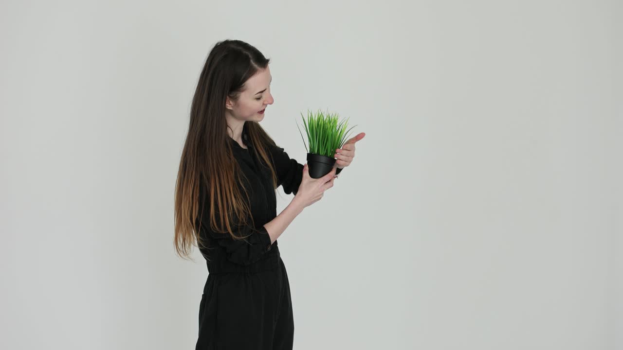 Woman holding artificial plant