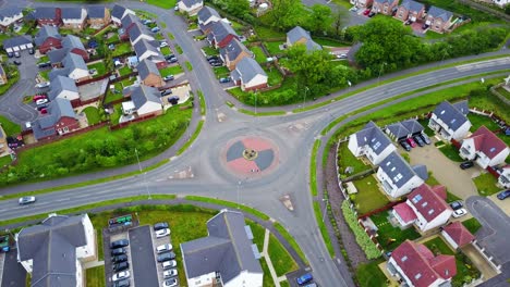 aerial view of road traffic roundabout in urban residential area