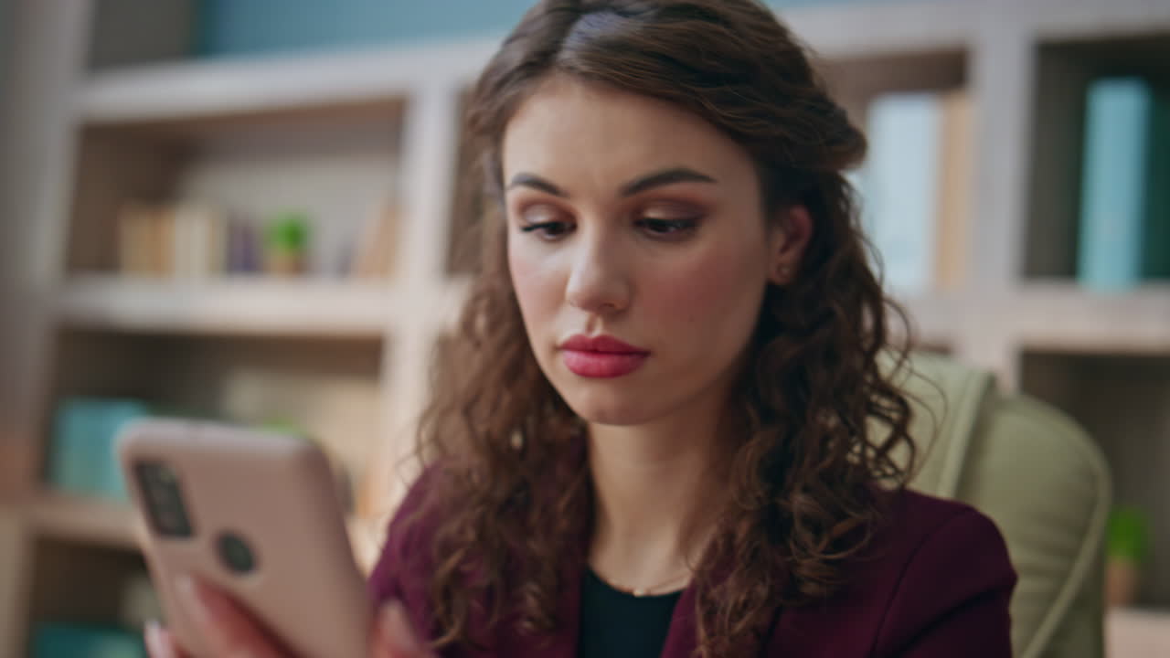 Unhappy executive looking smartphone message. Closeup hand picking mobile phone