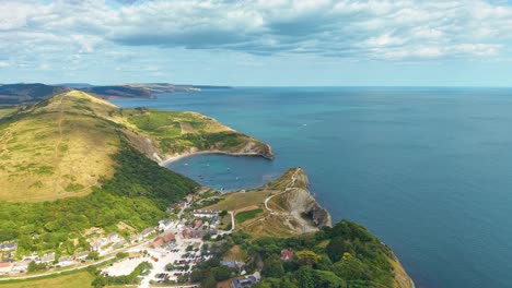 aerial drone footage flying towards scenic lulworth cove on the jurassic coast, dorset