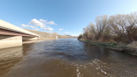 drone shot flying over nature landscape and river in montana, america