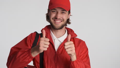 Caucasian-delivery-man-in-front-of-camera-on-white-background.