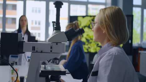 scientist using a microscope in a laboratory