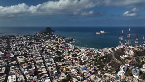 Drone-circling-the-coastal-cityscape-of-Mazatlan,-sunny-day-in-Sinaloa,-Mexico