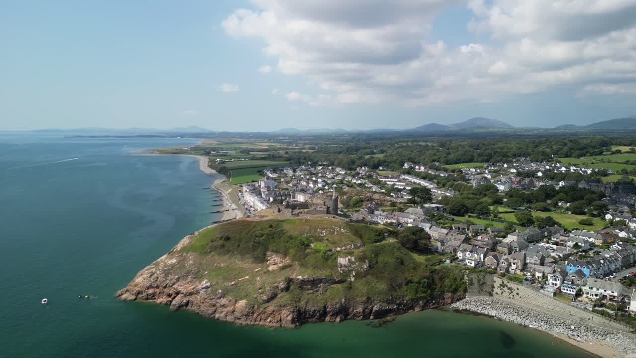 Stunning Criccieth Castle on a lovely summer afternoon - aerial drone anti-clockwise rotate and approach from far - North Wales, UK