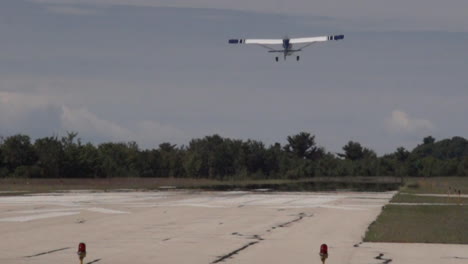 Northern-Michigan-Harbor-Springs-airport-Cessna-aircraft-airplane-private-pilot-fixed-single-engine-flight-takeoff-bluebird-summer-up-north-Mackinaw-Petosky-Grand-Rapids-scenic-landscape-slow-motion