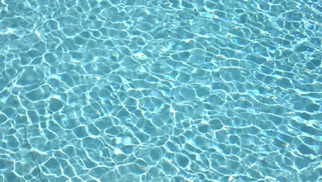 Water-surface-texture,-Slow-motion-clean-swimming-pool-ripples-and-wave,-Refraction-of-sunlight-top-view-texture-sea-side-white-sand,-sun-shine-water-background.-Water-Caustic-Background.