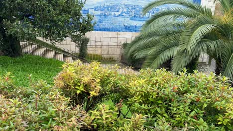 scenic mural at santa luzia viewpoint with palm trees and greenery.