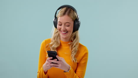 Woman,-headphones-and-phone-for-music