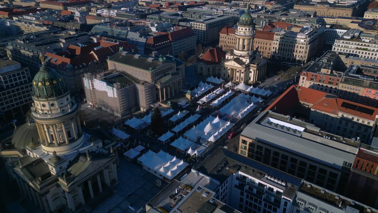 Christmas market tents and historic buildings in Berlin Gendarmenmarkt. speed ramp hyper motion time lapse Magic aerial view panorama orbit drone