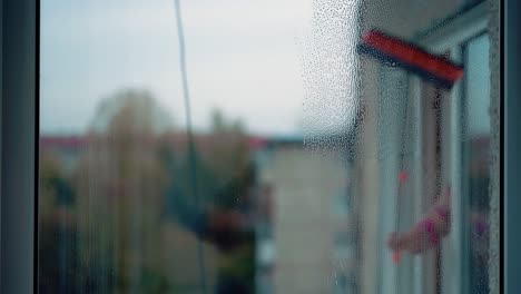 Young-girl-washes-windows-2-Closeup