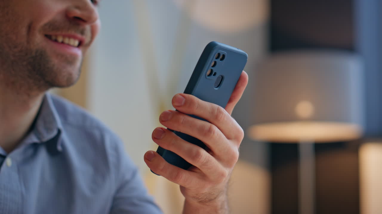 Smiling manager swiping screen work closeup. Cheerful man hands scrolling phone