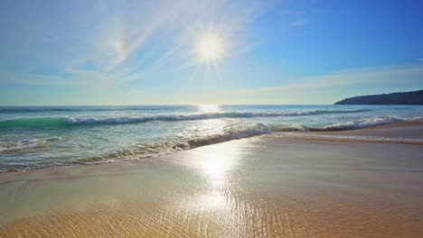 summer sea background with blue sky day and bright sun shining bright beautiful beach waves crashing on sandy shore at phuket island thailand