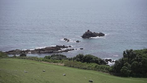 coastal view with rocks and lighthouse