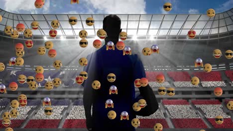 múltiples emojis de cara flotando sobre la vista trasera de un jugador de rugby masculino contra un estadio deportivo