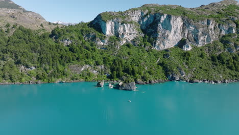 aerial flying over turquoise lake general carrera towards capillas de marmol