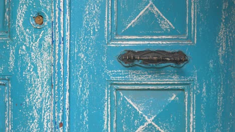 detailed view of an old, painted blue door