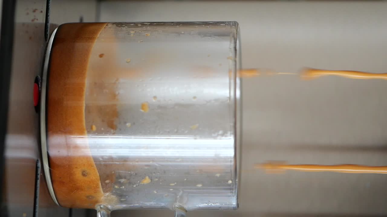 Espresso Being Poured into a Glass Cup