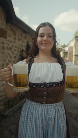 woman in dirndl holding beer mugs