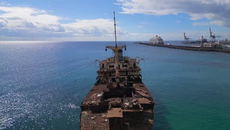 Great-aerial-view-flight-Ghost-ship-Shipwreck-on-beach-sandbank-Lanzarote-Canary-Islands,-sunny-day-Spain-2023