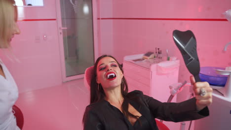 woman at the dentist with vampire teeth