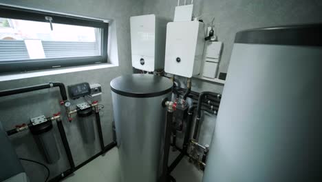 house boiler room interior with modern water heating system