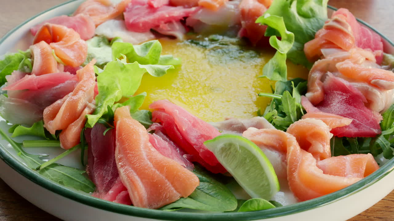 Farverig salatskål med frisk laks, tun, grønt og citrusdressing
