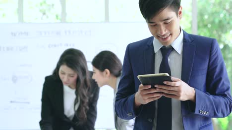 businessman hand hold smartphone in office brainstorm meeting