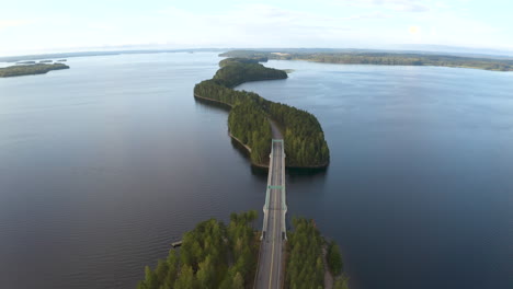 narrow islands connected by a bridge and road going through them in finland