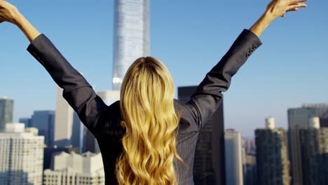 caucasian american businesswoman celebrating her success on rooftop