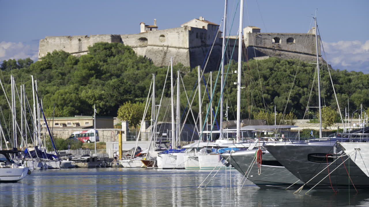 Antibes, France - June 7, 2025: Multiple white boats docked in the Port Vauban with the Fort Carre on the background in daylight