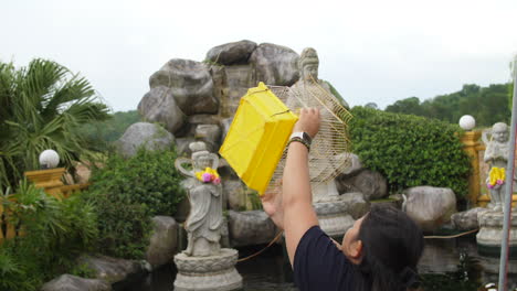 girl performing animal liberation ceremony at buddhist festival