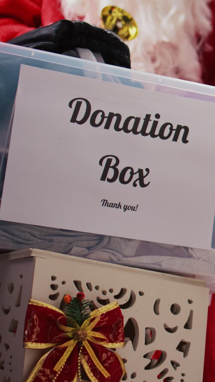 Vertical video Charity box in xmas adorn clothing store
