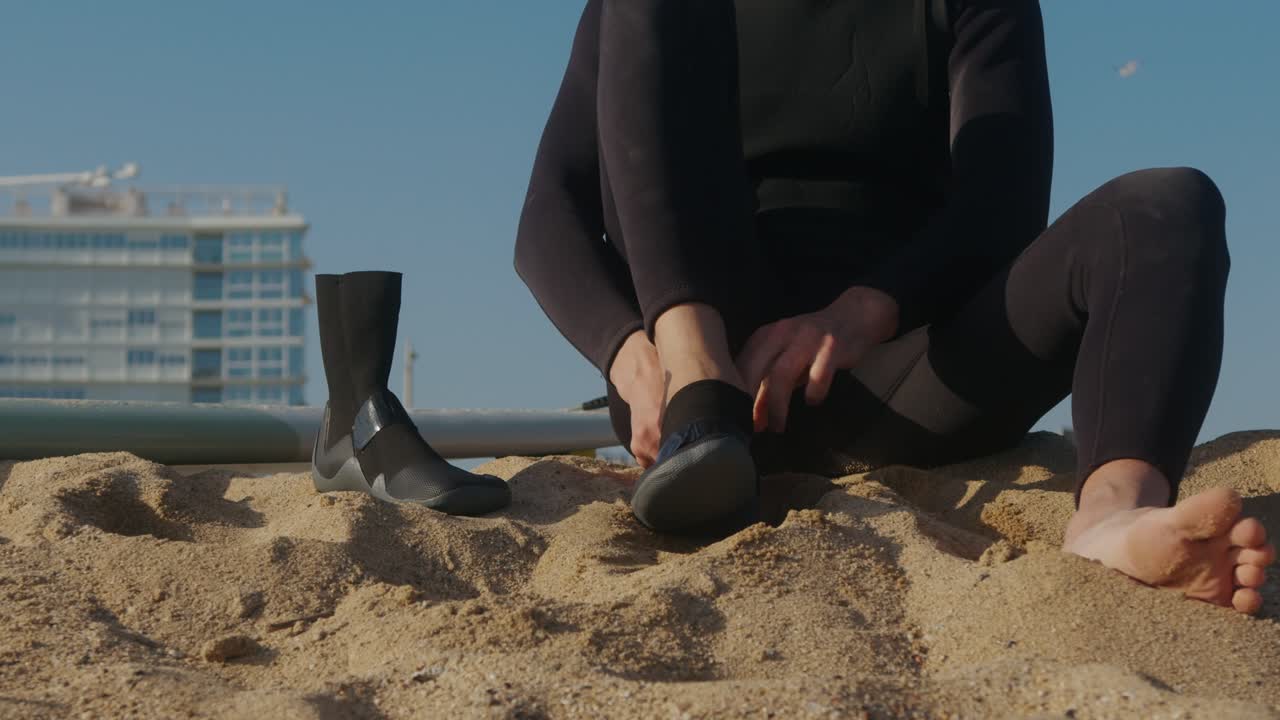 Surfer man walking to the beach at sunset preparing for surfing training and search for waves in Barcelona, spain, water, ocean exercise in sea with board, athletic male holiday or travel in vacation